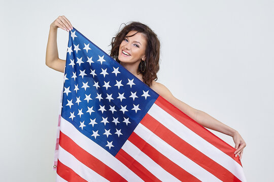 Attractive girl with American flag. photo session in the studio on a white background