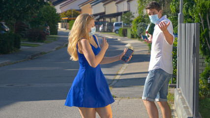 CLOSE UP: Neurotic girl starts spraying sanitizer after bumping into man.
