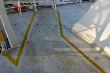 Safety walkway on ships deck. Yellow line walkway. Guided walkway on board. Passenger / contractor footpath on board offshore vessel.