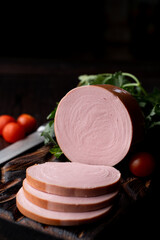 Pink bologna, sliced in thick pieces on dark background, magazine photo © Tkachenko Alexey
