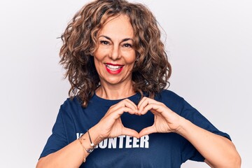 Middle age woman asking for social care wearing volunteer t-shirt over white background smiling in love doing heart symbol shape with hands. Romantic concept.