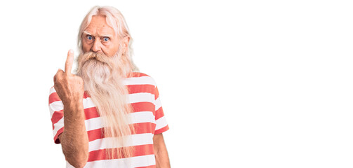 Old senior man with grey hair and long beard wearing striped tshirt showing middle finger, impolite...
