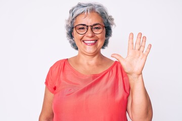 Senior hispanic grey- haired woman wearing casual clothes and glasses showing and pointing up with fingers number five while smiling confident and happy.