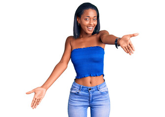 Young african american woman wearing casual summer clothes looking at the camera smiling with open arms for hug. cheerful expression embracing happiness.