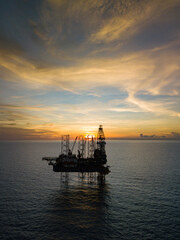Aerial view from a drone of an offshore jack up rig at the offshore location during sunset time