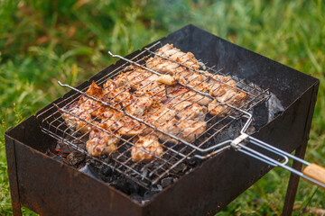 Grilled meat on the grill is cooked on coals