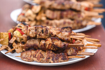 Shish kebab on wooden skewers is on a plate