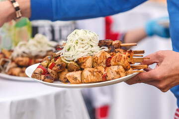 Shish kebab on wooden skewers is on a plate