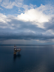 Fototapeta na wymiar Aerial view from a drone of an offshore jack up rig at the offshore location during raining time