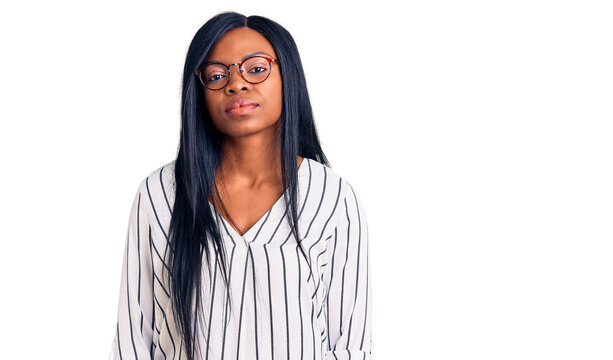 Young african american woman wearing casual clothes and glasses looking sleepy and tired, exhausted for fatigue and hangover, lazy eyes in the morning.