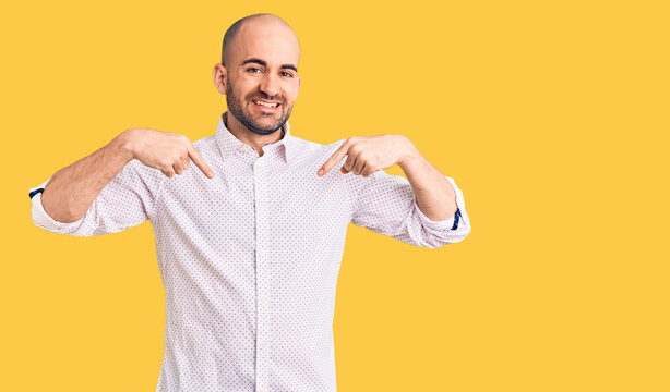 Young handsome man wearing elegant shirt looking confident with smile on face, pointing oneself with fingers proud and happy.