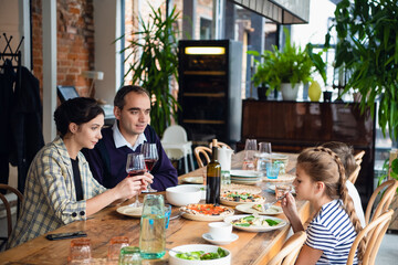 Smiling family dining together in a restaurant.