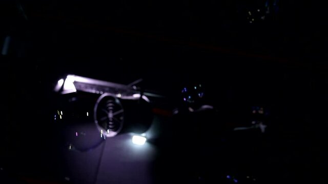 Close up autofocus animation shot of soap bubbles flying moving in air chaotically on neon violet blue dark background