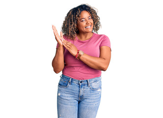 Young african american plus size woman wearing casual clothes clapping and applauding happy and joyful, smiling proud hands together