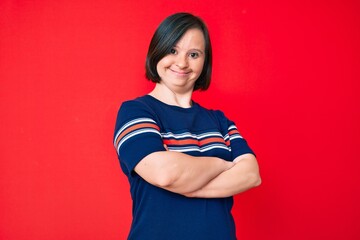 Brunette woman with down syndrome wearing casual clothes happy face smiling with crossed arms...