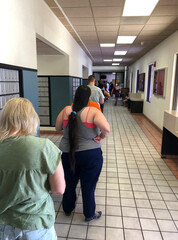 People waiting in a long line inside the foyer of the USPS building during the run-up to the 2020...