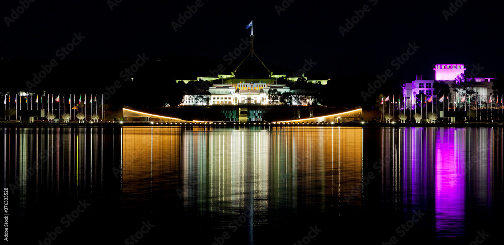 Wall mural Canberra Skyline with a reflection in the waters of Lake Burley Griffin. - Wall murals