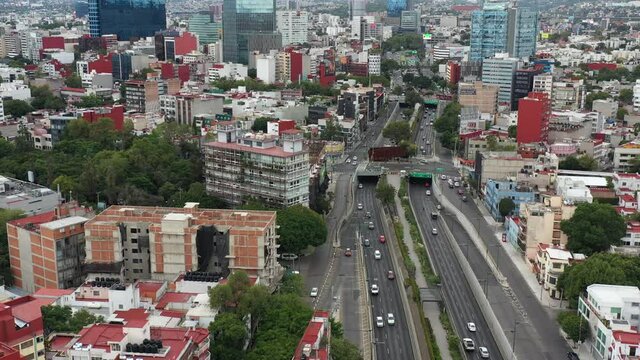 Vista a&eacute;rea sobre el Viaducto Miguel Aleman, con autos en circulando en ambos sentidos, y el Ecoducto R&iacute;o Becerra. El drone volando de forma lateral y con tr&aacute;fico en amb