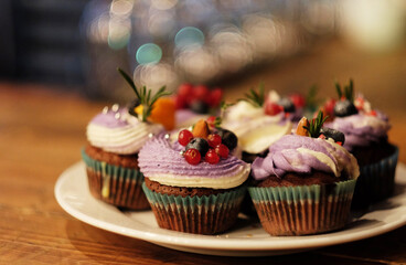 several cupcakes with fresh berries - currants and blueberries, close up