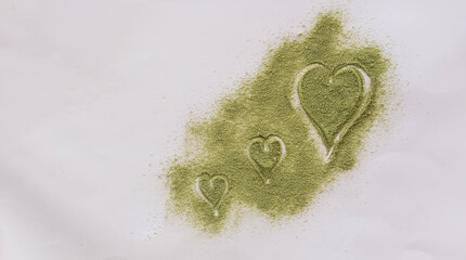 Green tea powder on a heart shaped background