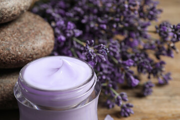 Obraz na płótnie Canvas Stones, jar of cream and lavender flowers on table, closeup