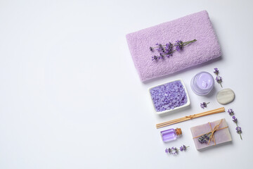 Cosmetic products and lavender flowers on white background, flat lay