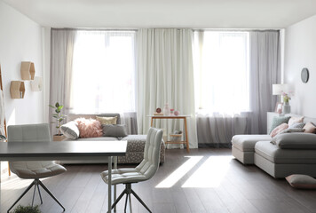 Fototapeta na wymiar Elegant living room with comfortable sofas near windows. Interior design