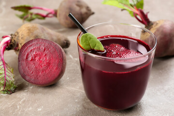 Freshly made beet juice on grey table