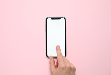 MYKOLAIV, UKRAINE - JULY 07, 2020: Woman using iPhone 11 on pink background, top view. Mockup for...