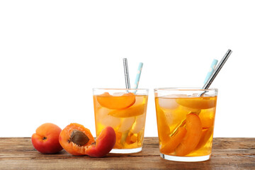 Delicious refreshing drink with apricot on wooden table against white background