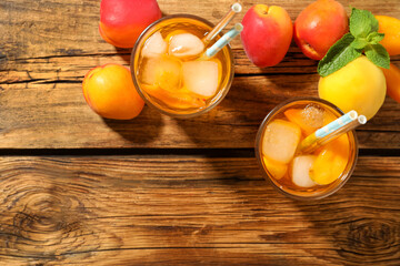 Delicious refreshing drink with apricot on wooden table, flat lay. Space for text