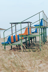 Empty stadium yellow and blue seats at the beach. Lockdown, end of Summer