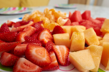 Colorful organic and healthy fruits sit on a marble table ready for a childrens lunch featuring a healthy and happy lifestyle