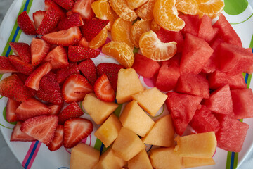 Colorful organic and healthy fruits sit on a marble table ready for a childrens lunch featuring a healthy and happy lifestyle