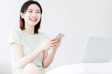 Women use mobile devices at home

