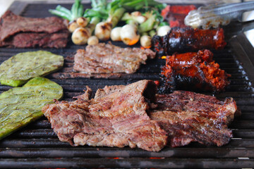 grilled meat with vegetables. Mexican food, snacks, nopal, meat, onions.
