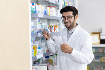 Middle eastern male pharmacist selling medications to patient in modern pharmacy prescription