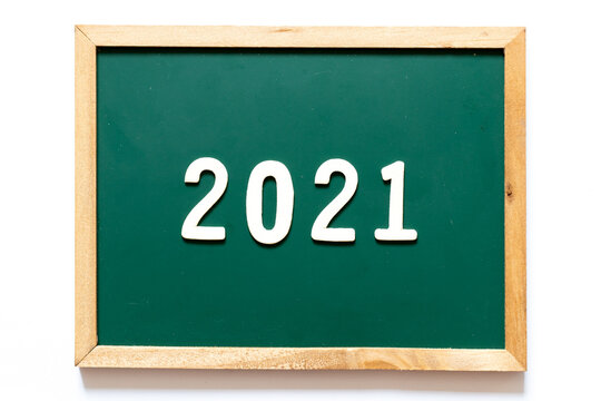 Green blackboard and wood frame with word 2021 on white background