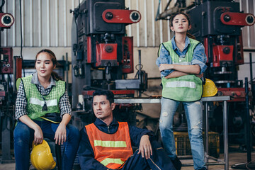 Asian woman and man engineers or technician worker in industry manufacturing hearing bad news of getting fired. stressed people from being terminate or factory close during Coronavirus outbreak crisis