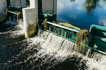 Water dam on a river. Water level regulation. Environment industry background. Summer draught low...