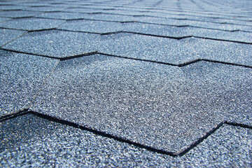 Obraz premium Gray soft roof on the roof of the house. Close-up.