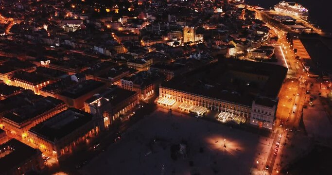 Aerial view of illuminated downtown of Lisbon overlooking Commerce Square with Rua Augusta Arch at night, Portugal. High quality 4k footage