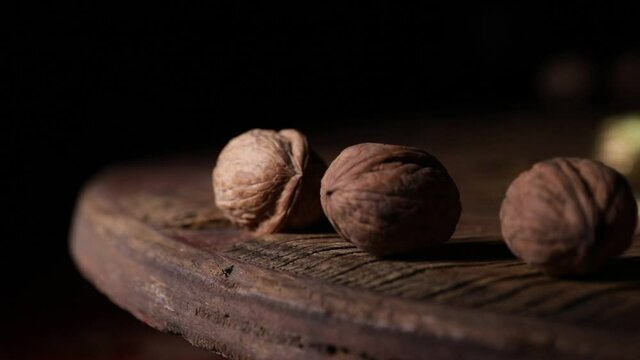 Nut meal concept. Walnuts rotating on wooden plate.  Selective focus