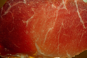 photo of a thin section of pork meat with illumination from the bottom close-up for the background