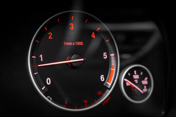 Fototapeta premium dashboard of the car is illuminated by bright circle tachometer.
