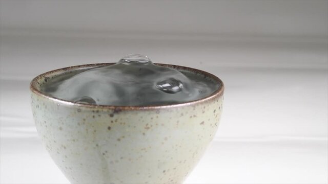 Serving Sake and spilling it