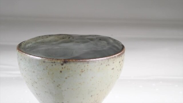 Serving Sake in a ceramic glass