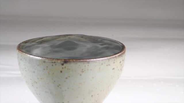 vibration of sake in ceramic glass