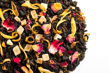 Delicious sweet dried tea close-up. Flavored tea with candied fruit slices, tiger Lily petals, hibiscus, rose