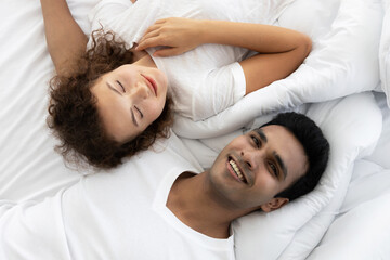 Top view of romance couple lying on the bed in bedroom